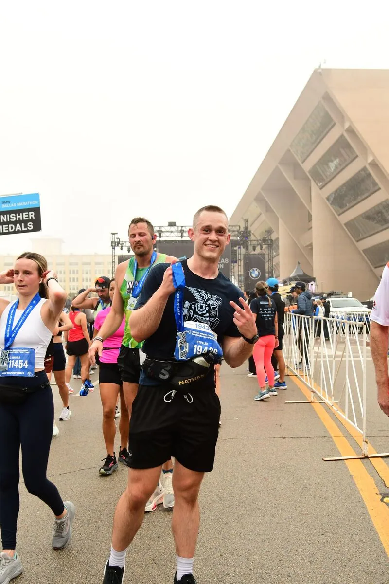 Josh crossing the half marathon finish line